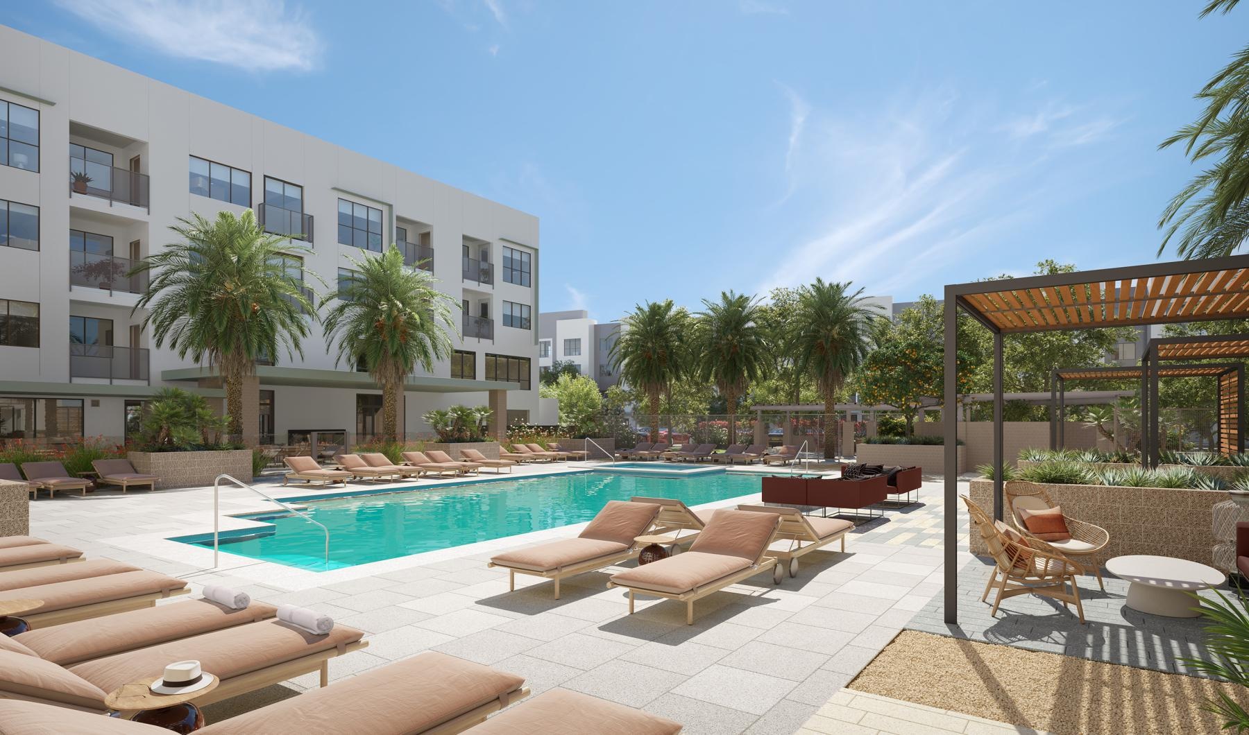 a swimming pool with lounge chairs and a building in the background